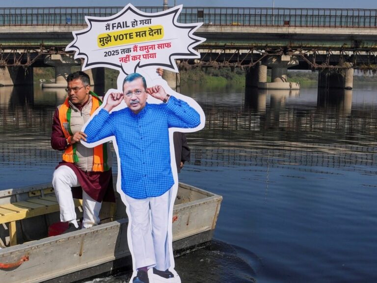 बीजेपी उम्मीदवार प्रवेश वर्मा ने यमुना में डुबोया केजरीवाल का कट-आउट, प्रदूषण पर किया कटाक्ष